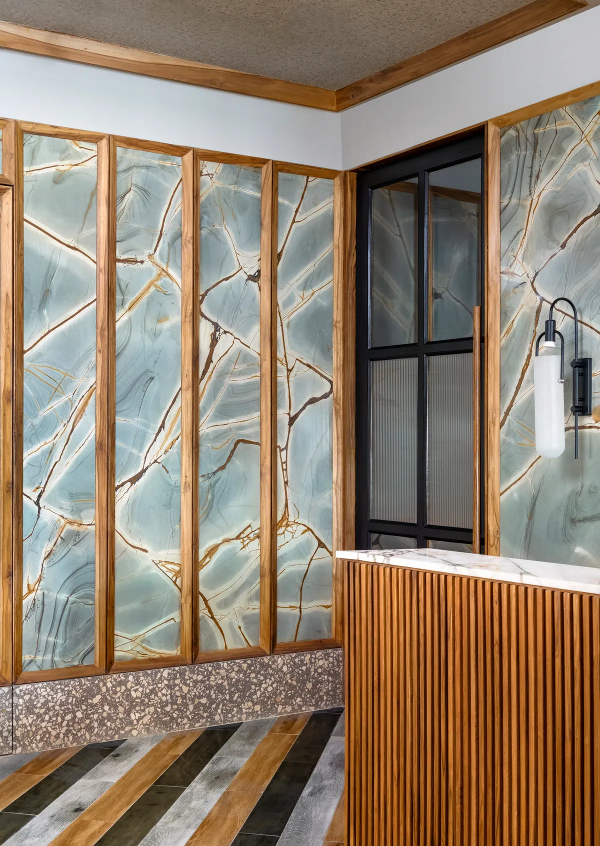 Reception wall — blue stone and teak detail